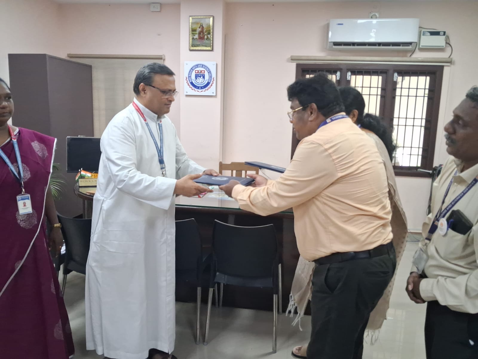 A memorandum of understanding being exchanged between BMIT and a college